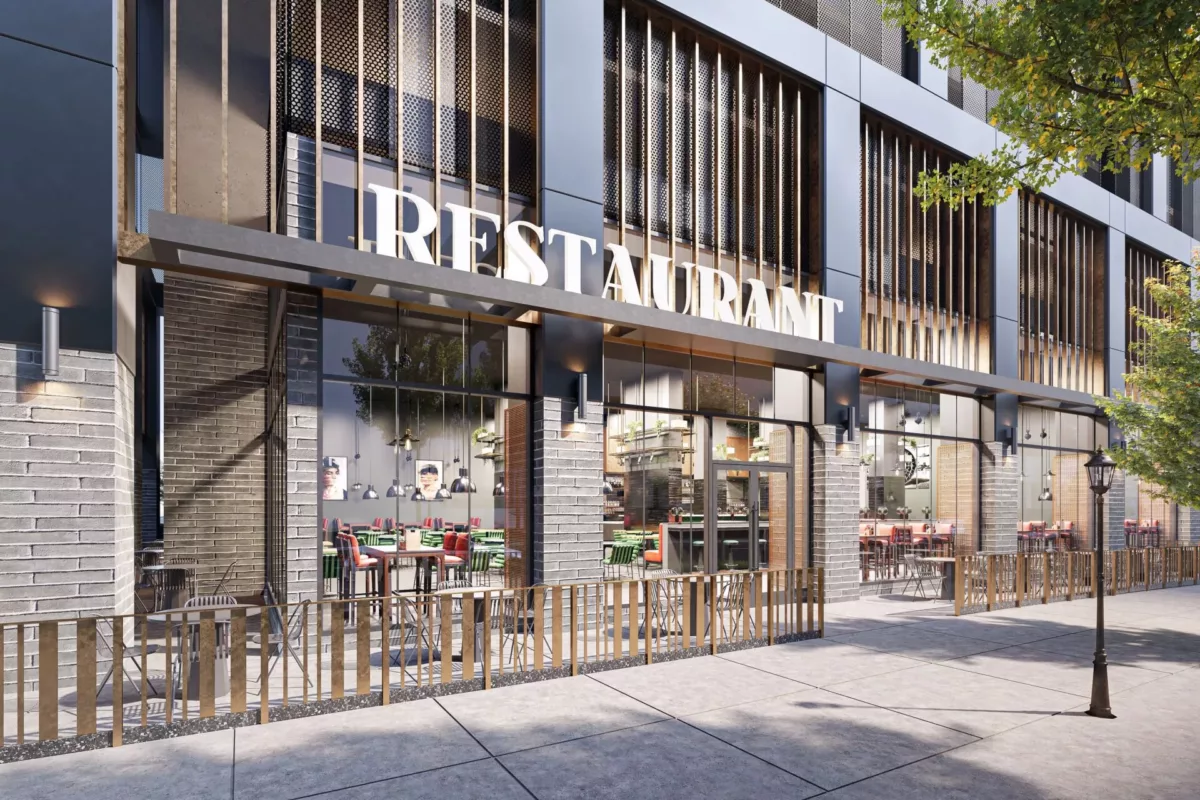 Exterior of a restaurant with large windows, an outdoor seating area, and a modern design featuring vertical slats.