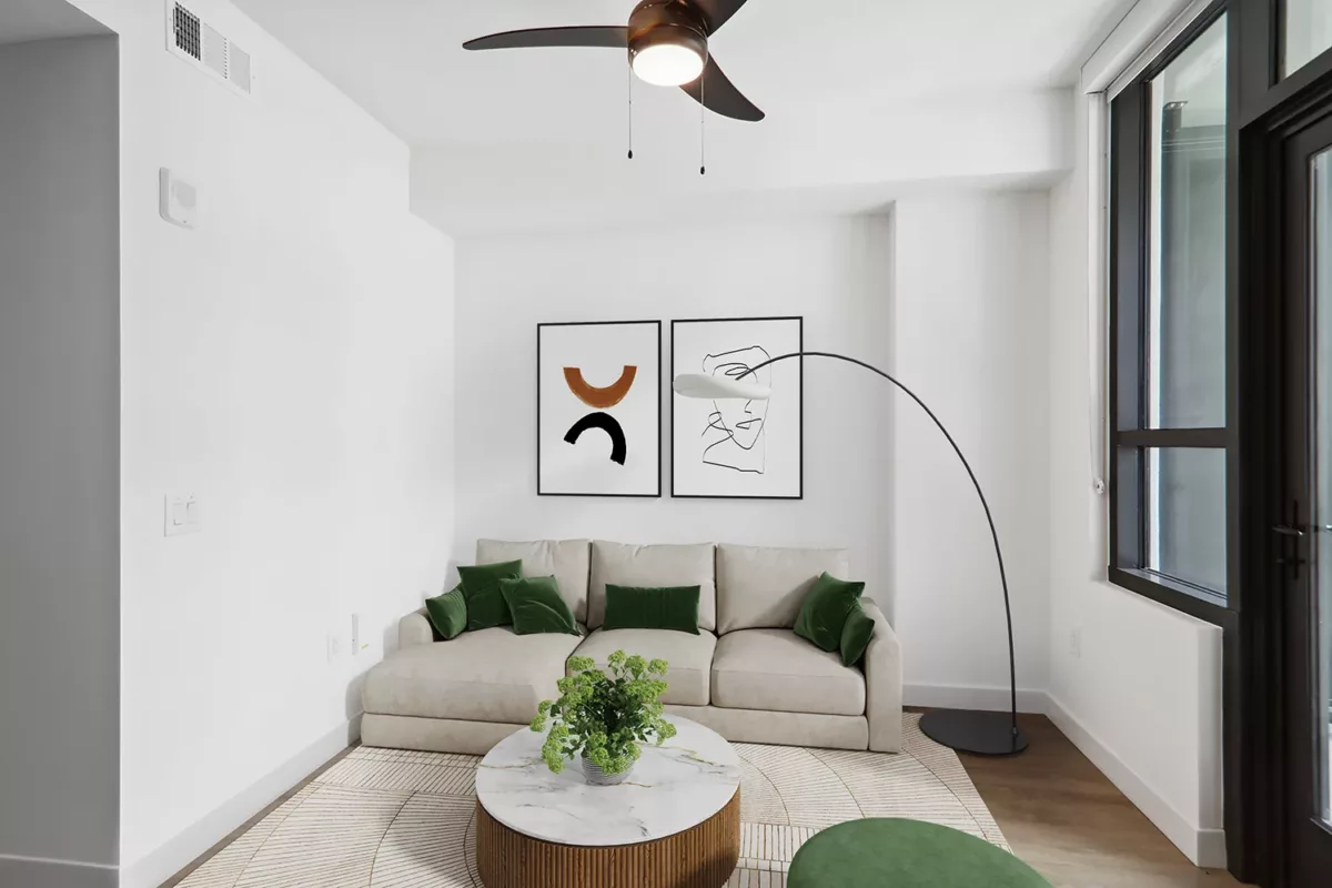 Living room with a beige sofa, marble-top coffee table, and minimalist artwork on the wall.