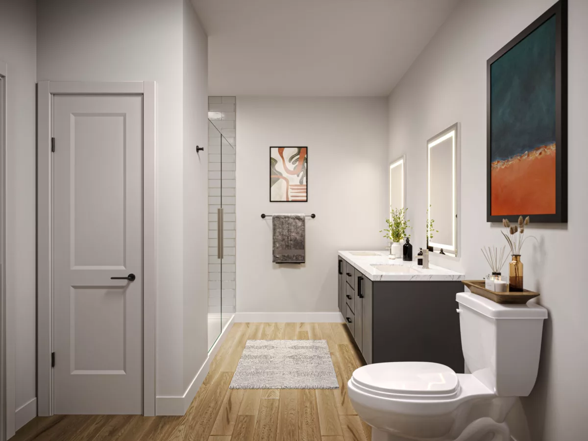 Neutral bathroom at Momentum with double vanity, black cabinetry, and subway tile standing shower.